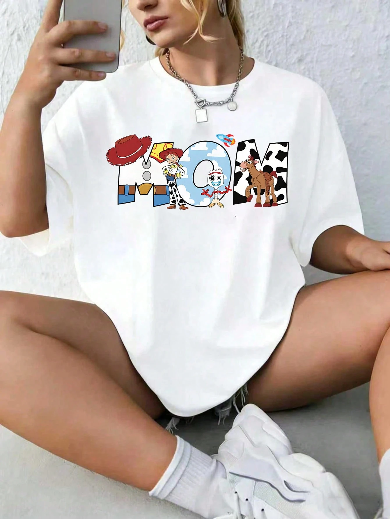 This Officially Licensed Disney Women's Summer T-Shirt From The *Toy Story* Collection Features Prints Of Jessie, Forky, And A Heart-Shaped "Mom" Graphic. With Its Casual And Adorable Style-Crafted From Ultra-Soft, Breathable Fabric-It Is The Perfect Choice For Celebrating Mother's Day Or For Family Outings.